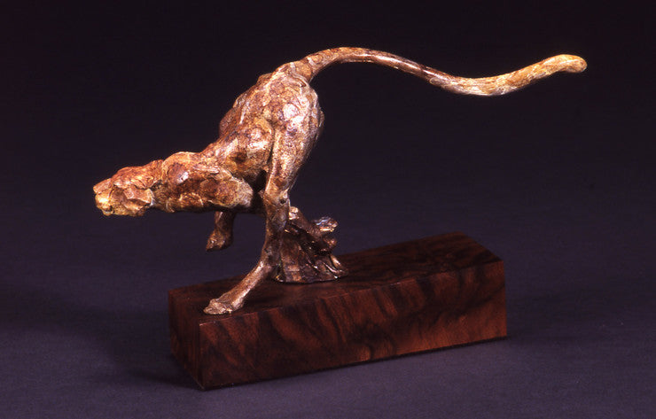 bronze sculpture of a cheetah running